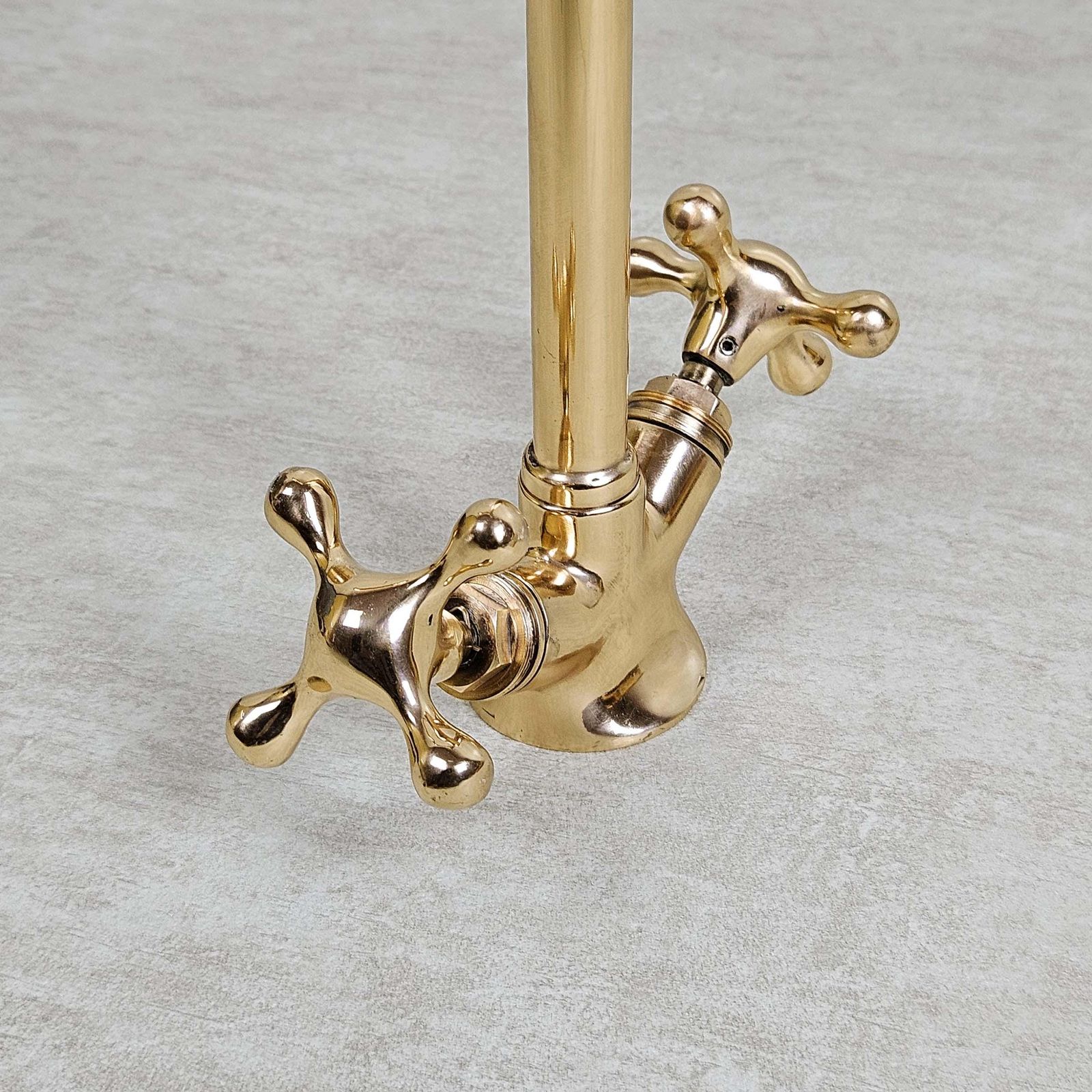 Gold faucet on a gray background