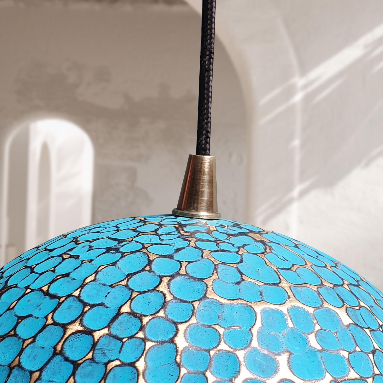 Blue mosaic pendant light with a textured surface