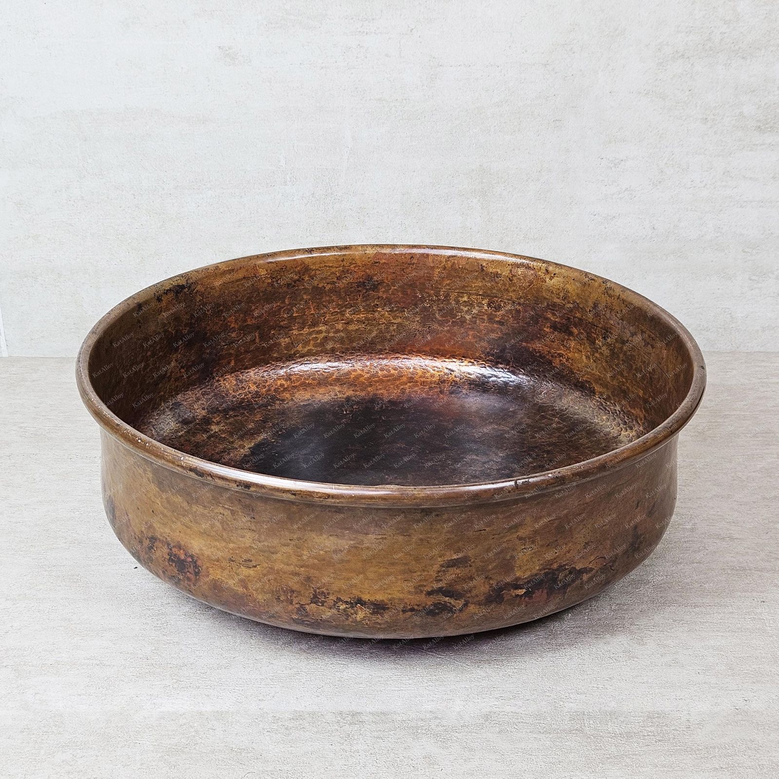 aged copper bowl on a textured gray background