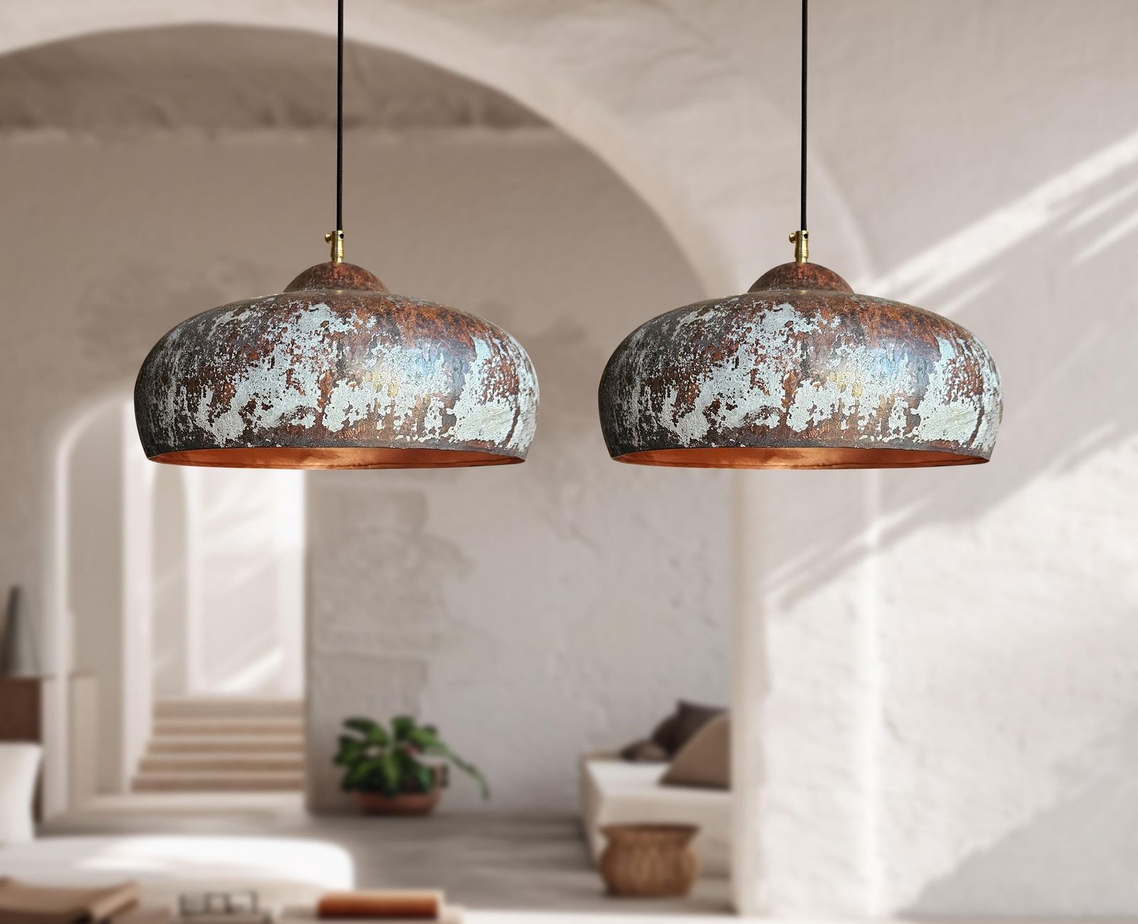 Two rustic pendant lights hanging in a room with a neutral color palette.