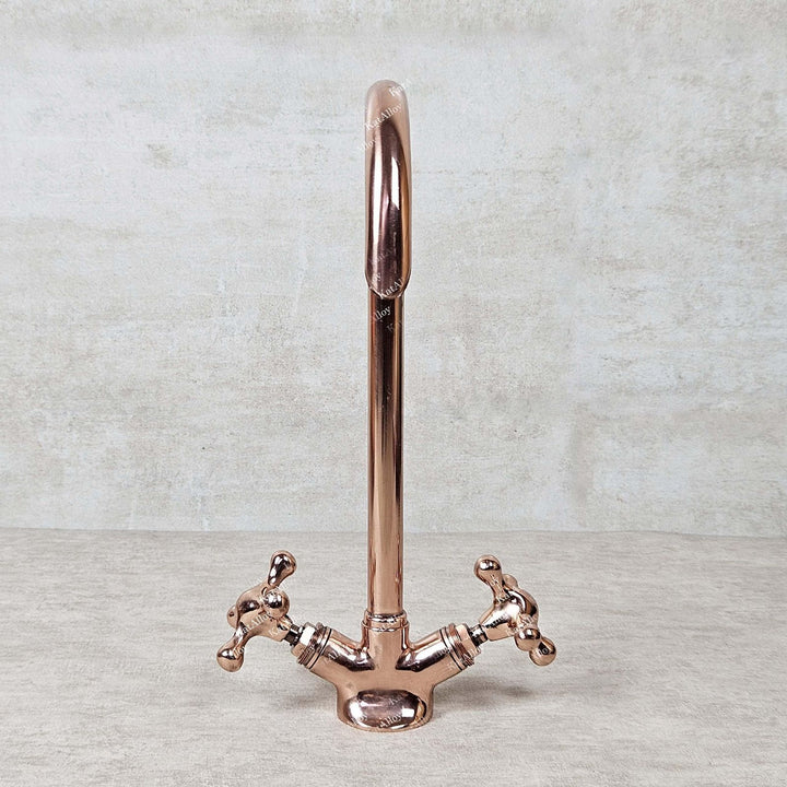 Rose gold kitchen faucet on a light gray background