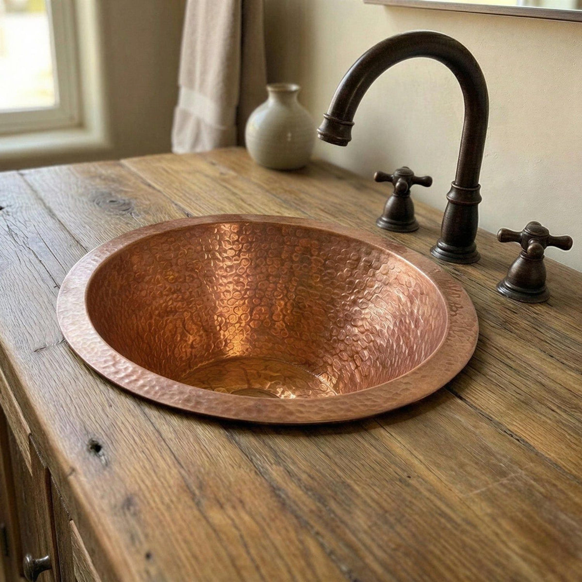 Copper sink on a wooden countertop with a faucet