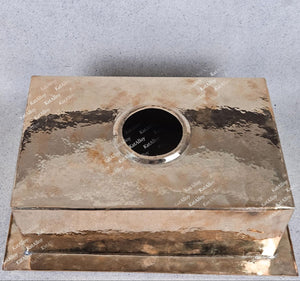 Metallic box with a circular opening on a gray background