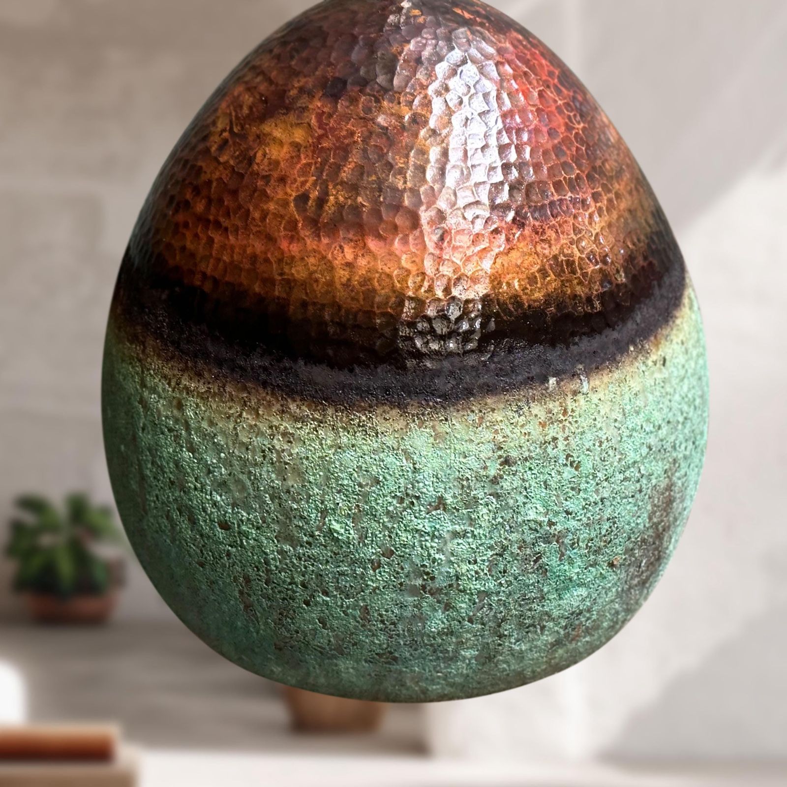 Decorative sphere with gradient colors on a neutral background