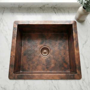 Copper kitchen sink on a marble countertop