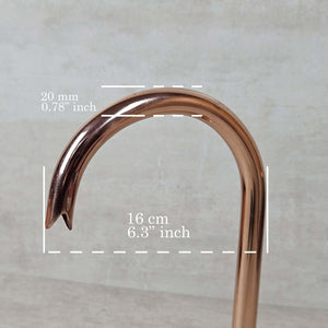 Copper pipe with measurements on a gray background