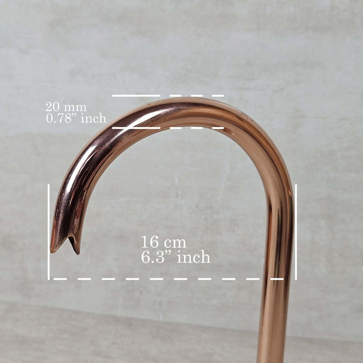 Copper pipe with measurements on a gray background