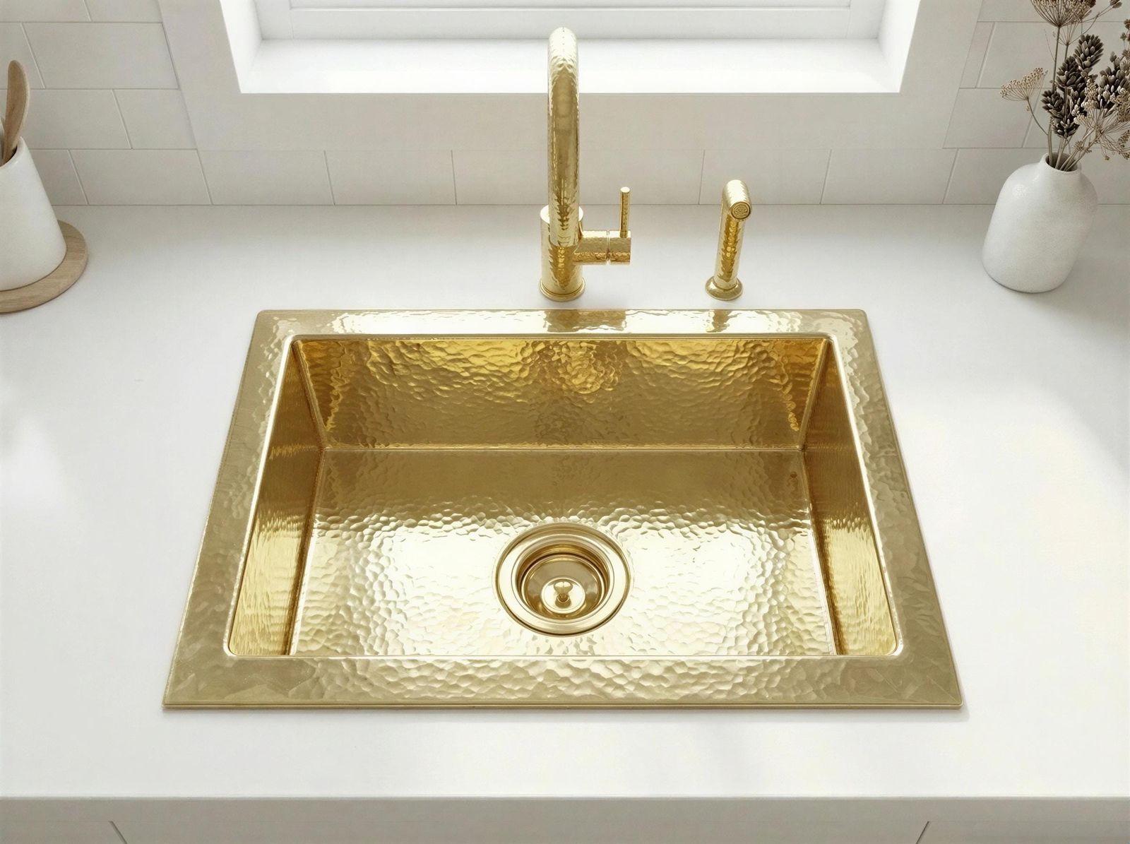 Gold sink with faucet on a white countertop