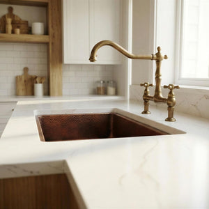 Kitchen with a copper sink and brass faucet