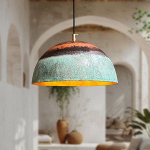 Decorative pendant light with a textured design hanging in a room with plants and arches.