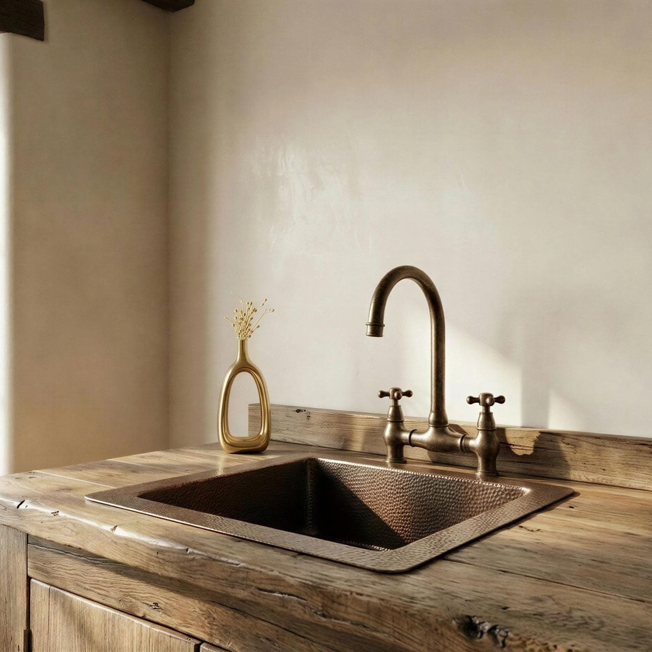 Copper kitchen sink with faucet on a wooden countertop