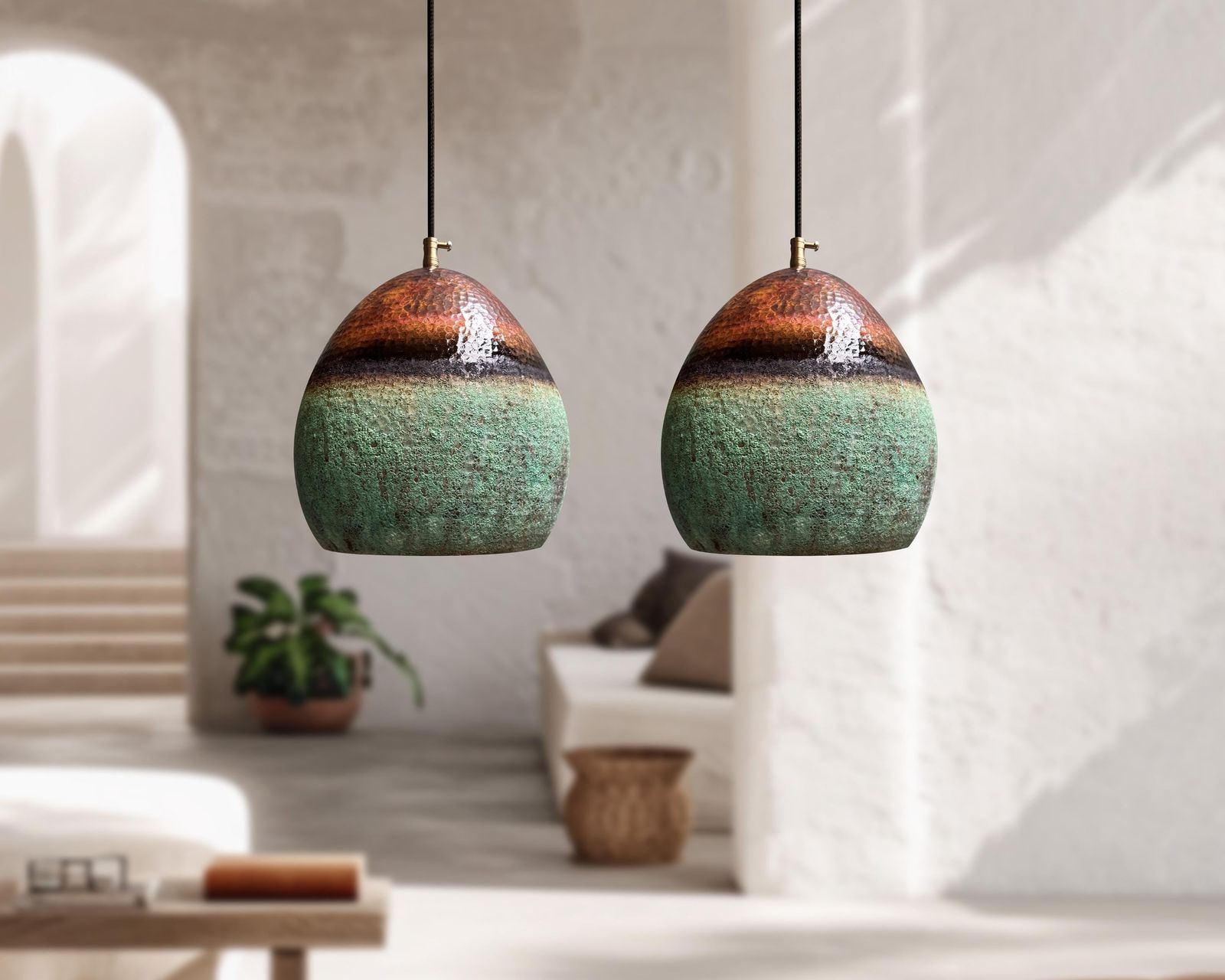 Two ceramic pendant lights hanging in a modern living room.