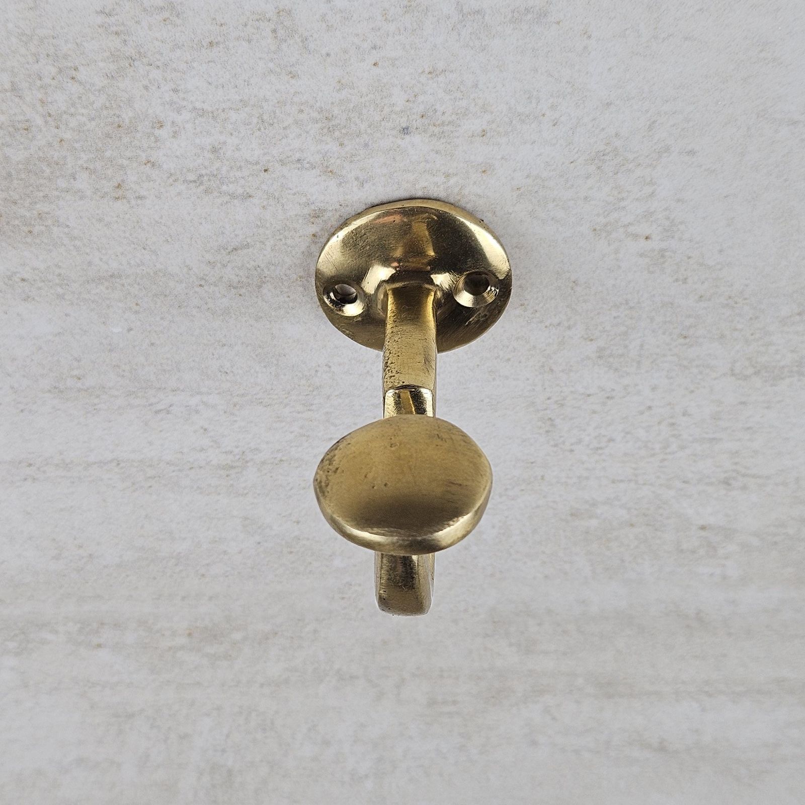Brass door handle on a textured gray background