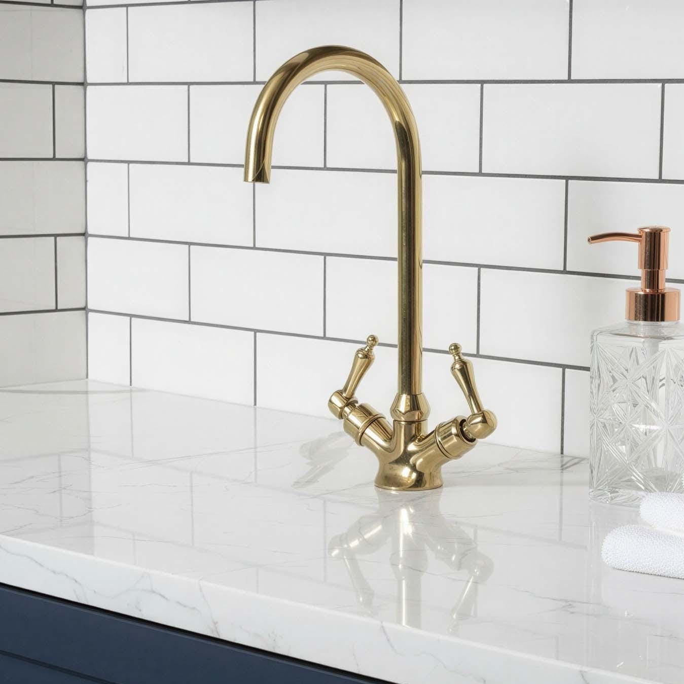 Kitchen sink area with gold faucet, white countertop, and blue cabinets.
