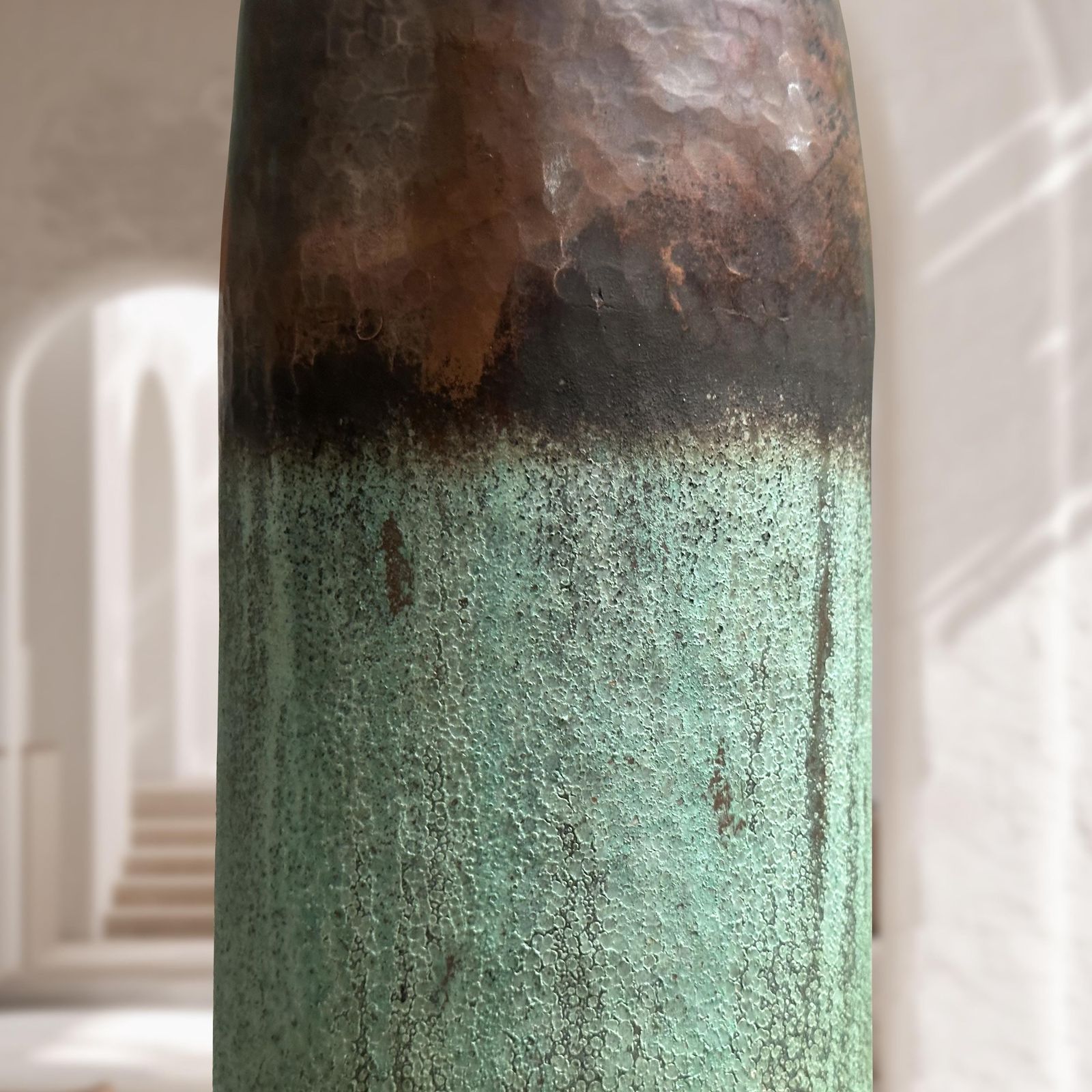 Close-up of a textured cylindrical object with gradient colors on a blurred background