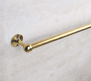 Gold towel bar on a light gray background
