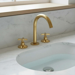 Gold faucet and handles on a marble sink