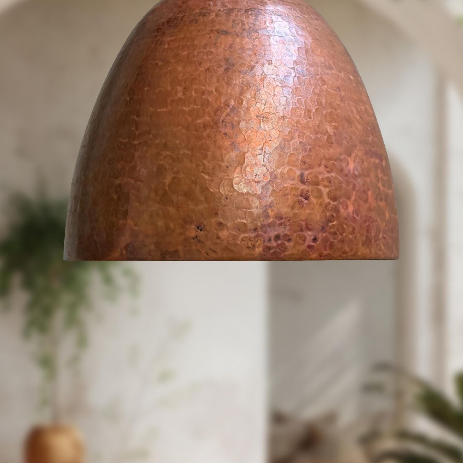 Copper lampshade with a textured surface on a blurred background