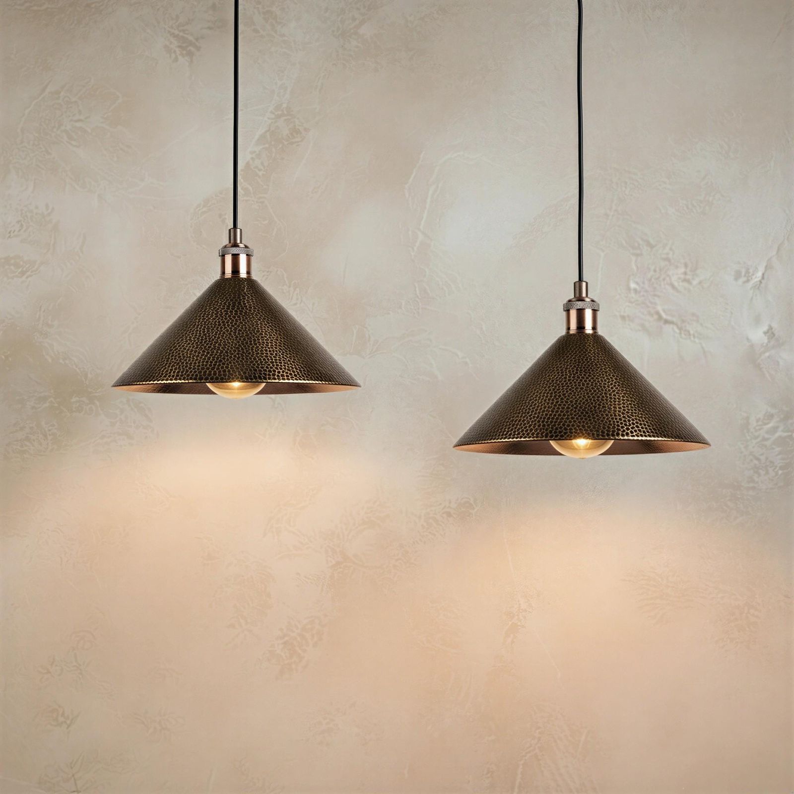 Industrial cone pendant lamp featuring a dimpled metal texture and copper accent hardware hanging from a black cord.