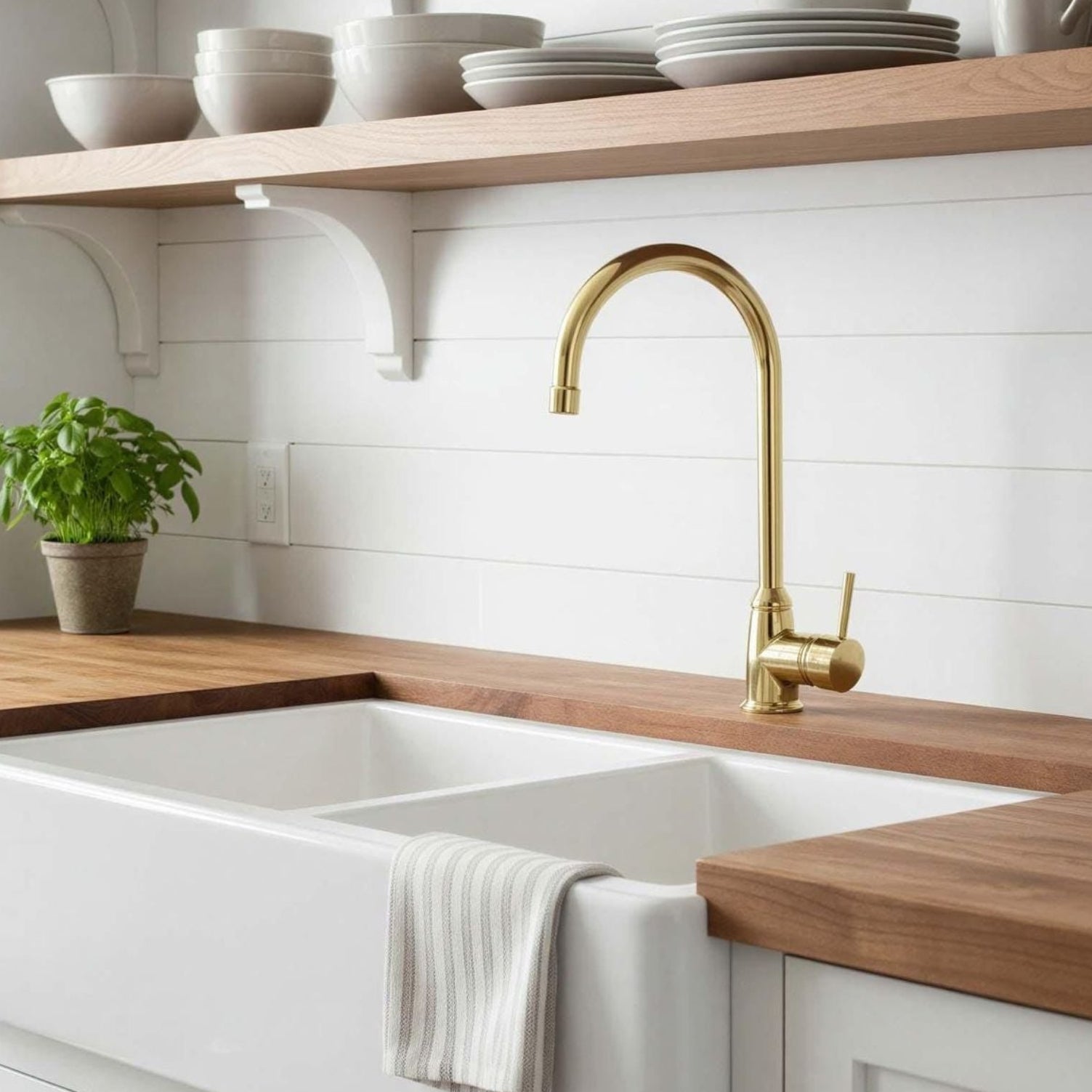 Modern kitchen with white sink, wooden countertops, and gold faucet.