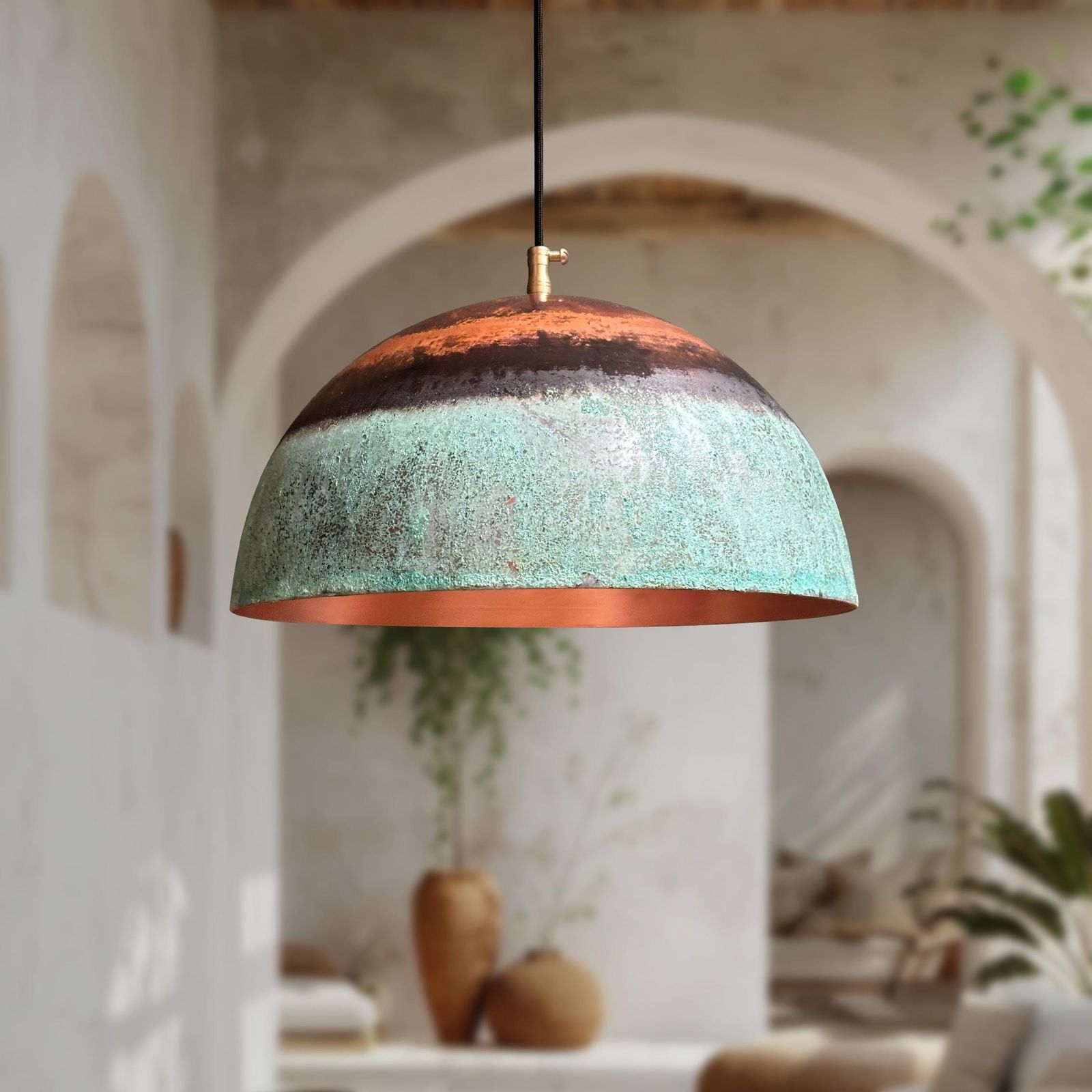 Decorative pendant light with a textured design hanging in a room with plants and arches.