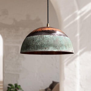 Dome-shaped pendant light with a textured surface in a softly lit room.