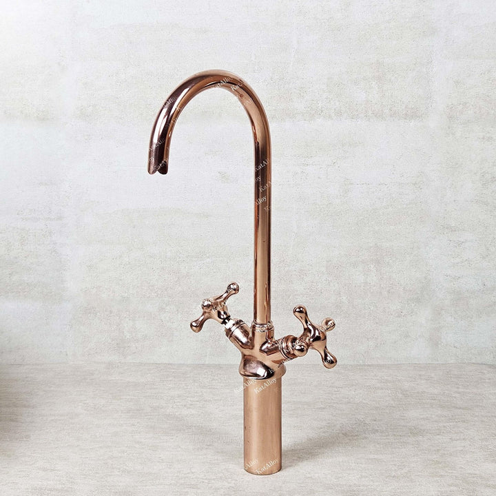 Rose gold kitchen faucet on a light gray background