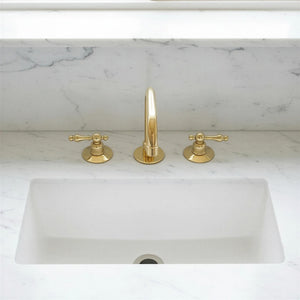 Gold faucet and handles on a marble countertop