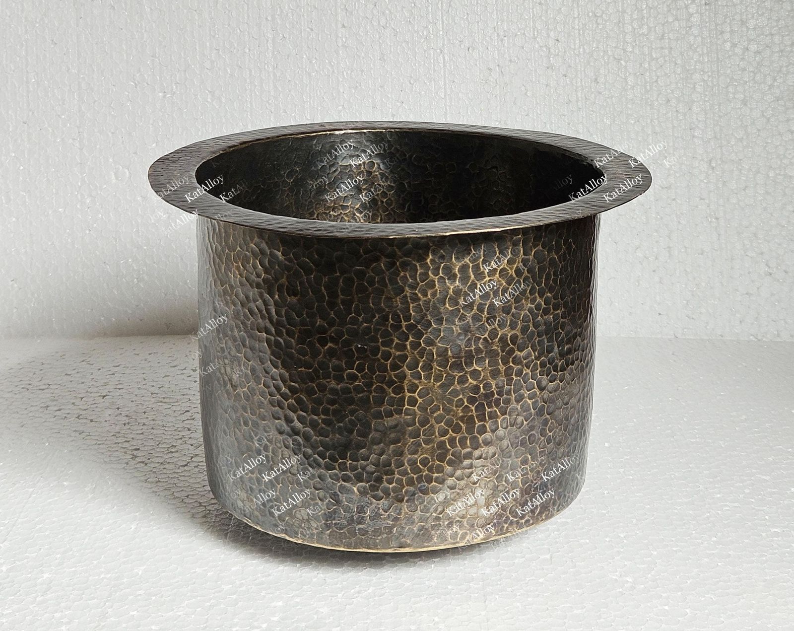 Hammered metal pot on a white background