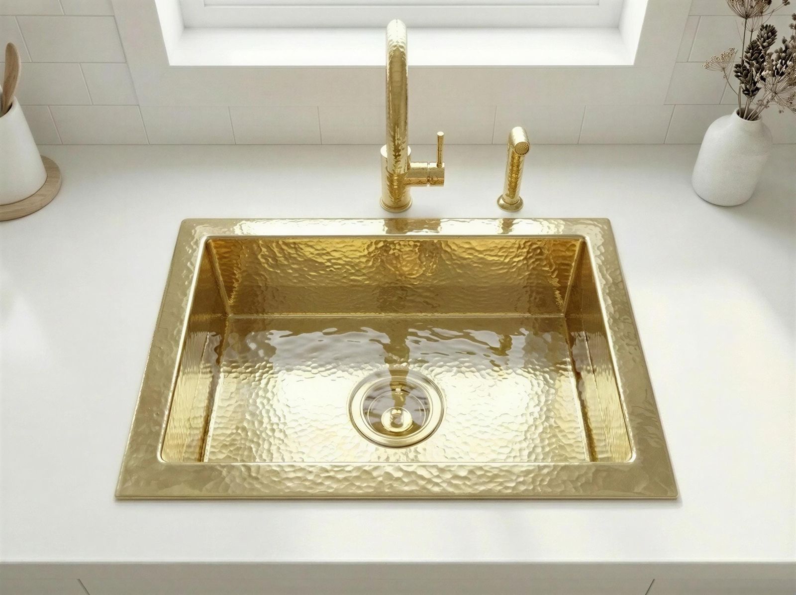 Gold sink with faucet on a white countertop