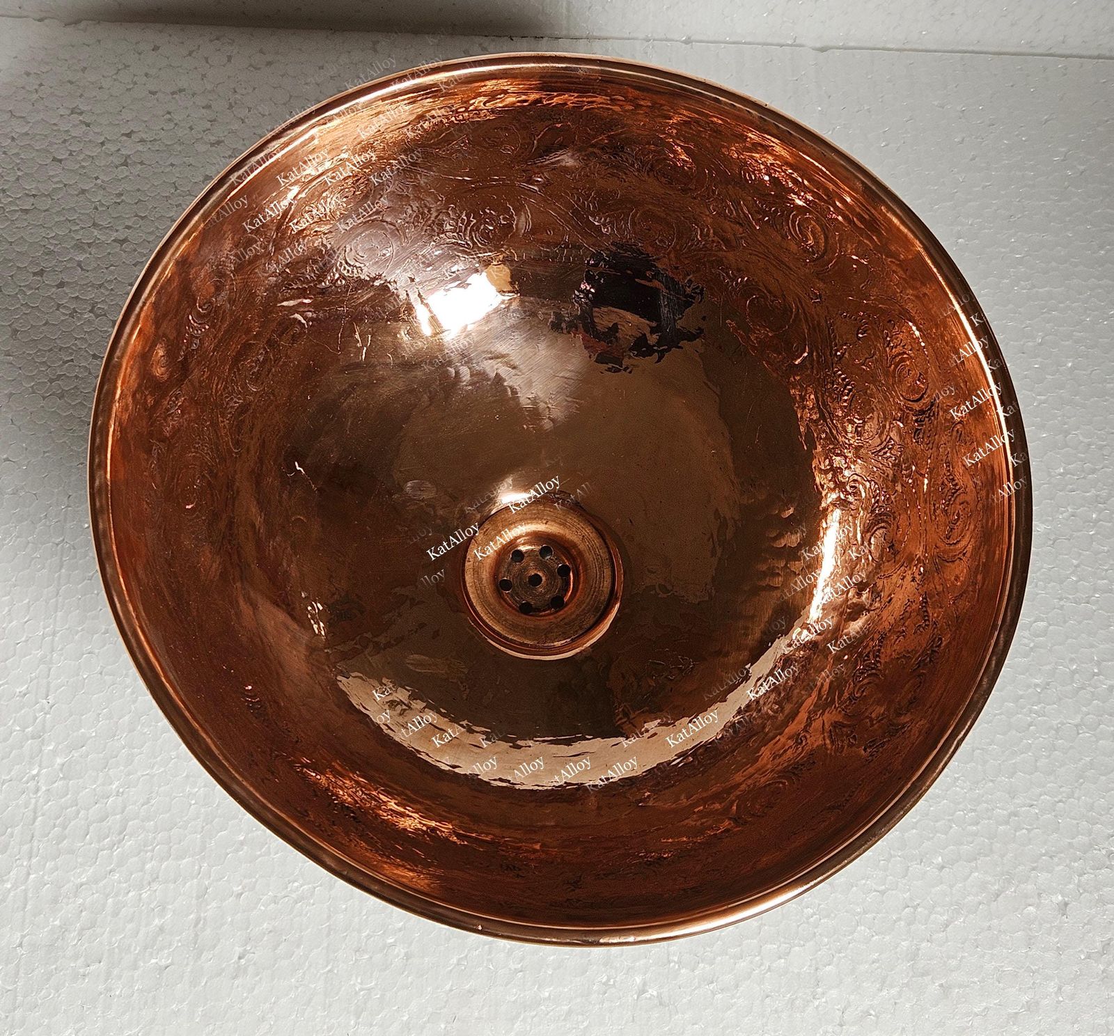 Copper sink basin on a light gray background