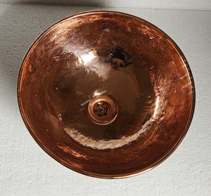 Copper sink basin on a light gray background