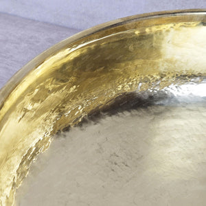 Gold decorative item on a textured surface