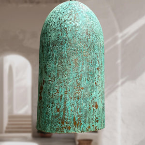 Turquoise ceramic vase with a textured surface on a white background