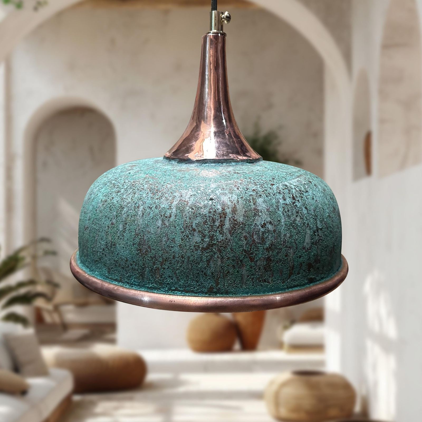 Turquoise pendant light with copper accents in a blurred indoor setting