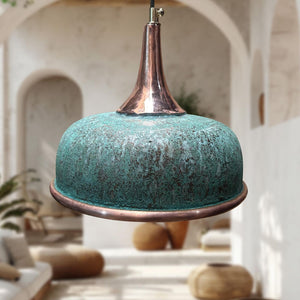 Turquoise pendant light with copper accents in a blurred indoor setting