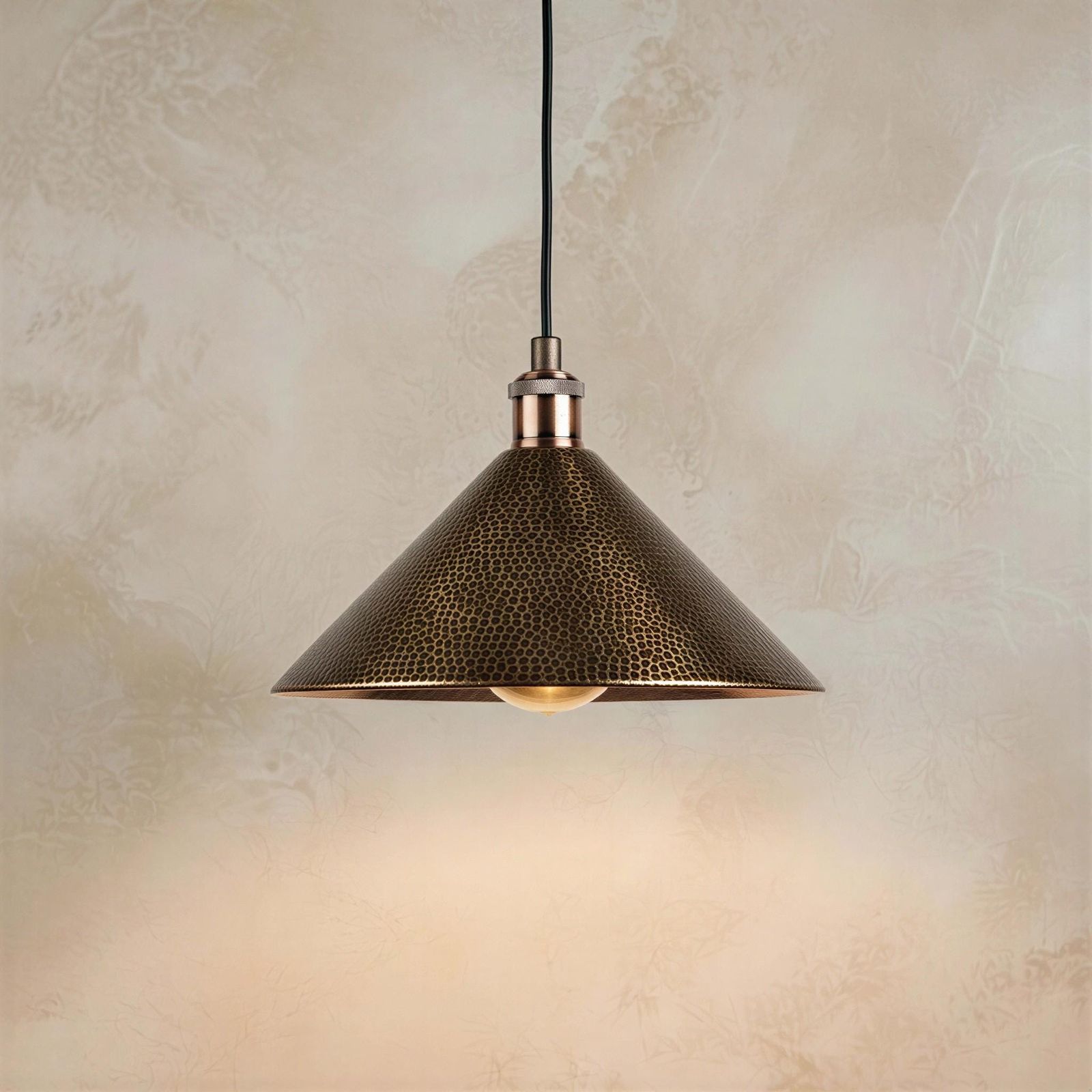 Vintage textured cone ceiling light fixture showcasing a metallic leopard-spotted finish with a warm amber light glowing underneath.