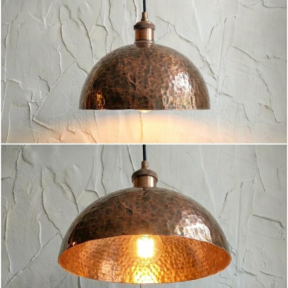 Copper pendant light fixture on a textured wall background