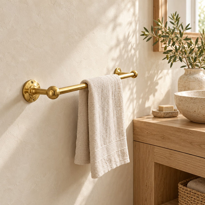 Classic solid brass towel bar with linen towel in a bright farmhouse bathroom