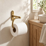 Curved solid brass toilet paper holder in a warm neutral farmhouse bathroom