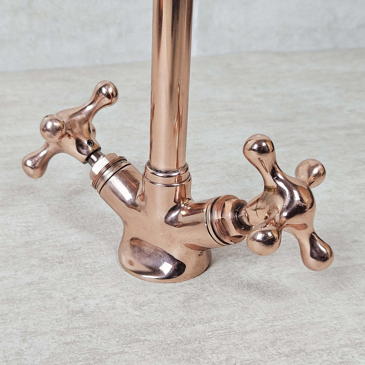 Rose gold kitchen faucet on a light gray background