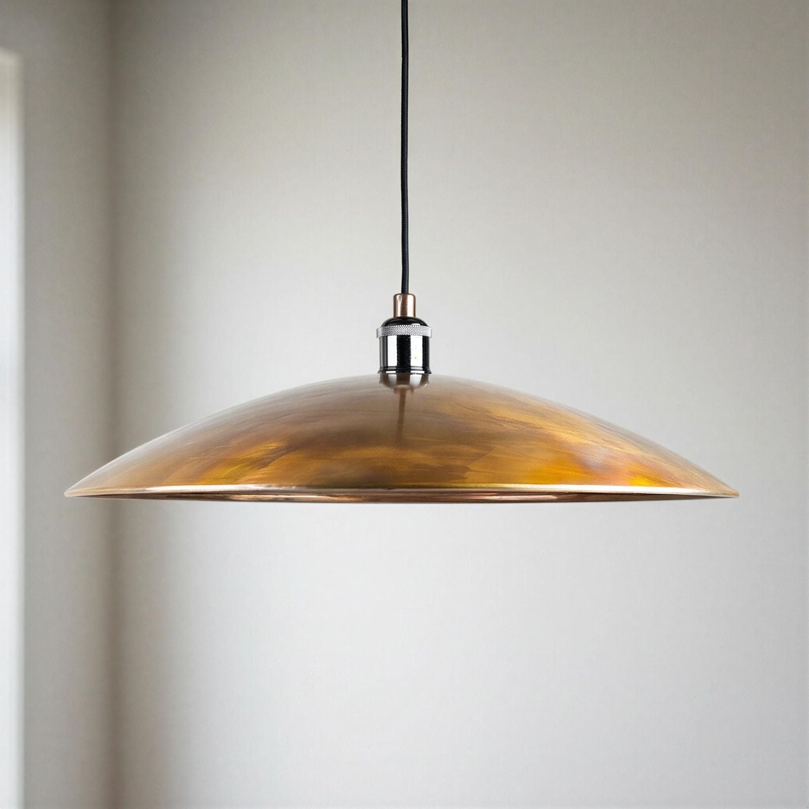 copper pendant light against a neutral background