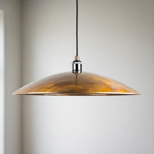 copper pendant light against a neutral background