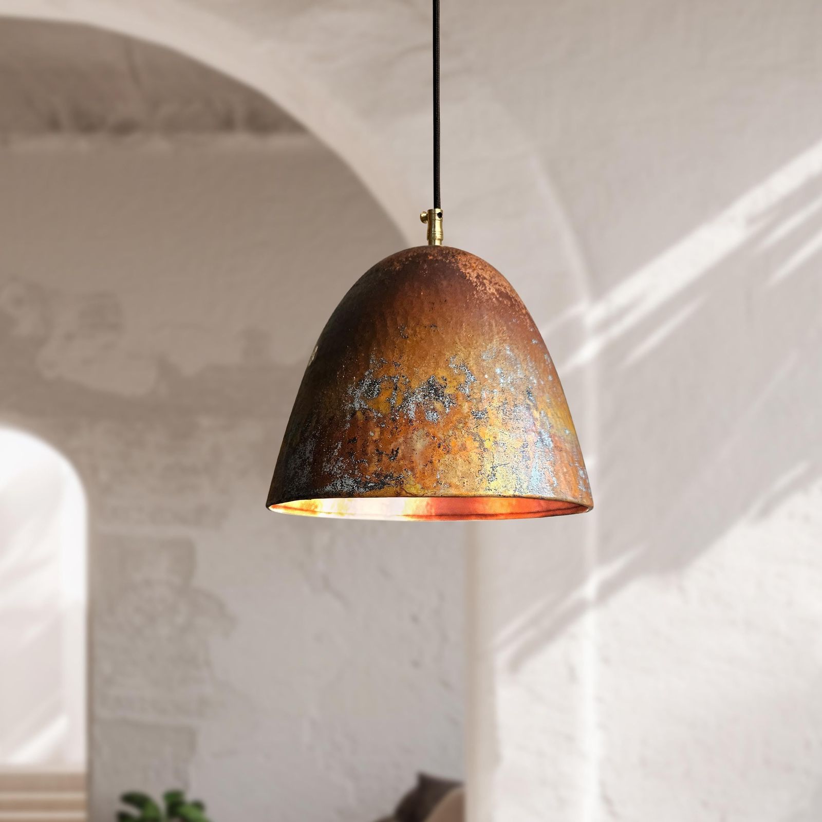 Rust-colored pendant light hanging against a neutral wall.
