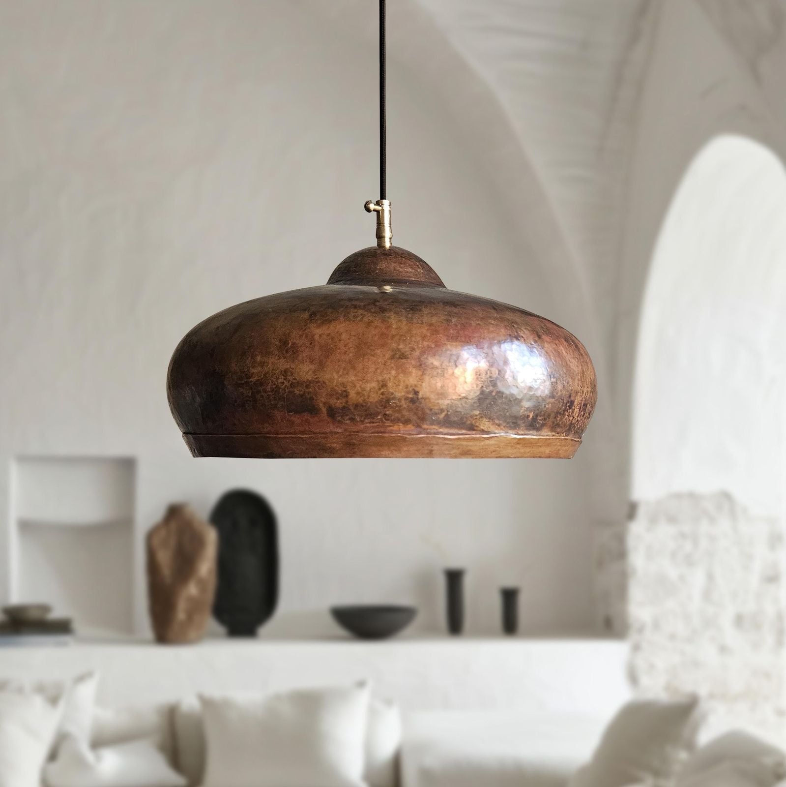 rustic copper pendant light hanging in a modern interior setting