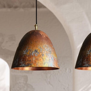 Rustic pendant light with a textured surface on a neutral background