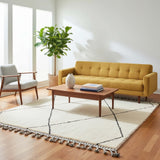 Ivory Black Diamond Wool Rug with Orange Tassels styled in a bright living room