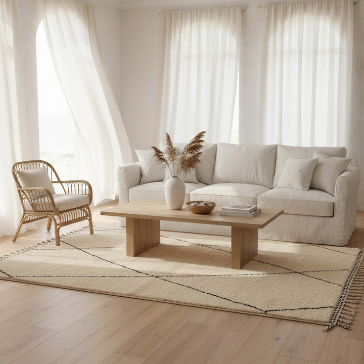 Ivory Black Diamond Wool Rug with Orange Tassels styled in a modern interior