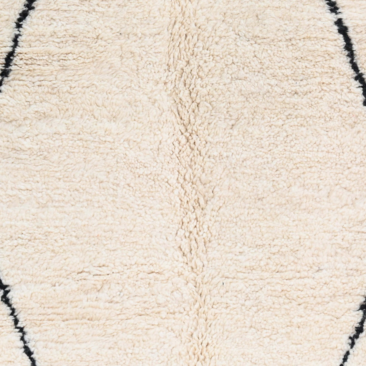 Handwoven wool texture of Ivory Black Diamond Wool Rug with Orange Tassels