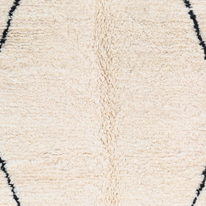 Handwoven wool texture of Ivory Black Diamond Wool Rug with Orange Tassels